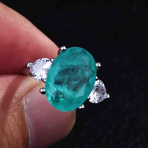 Macro view of the large oval teal gemstone ring with pear-shaped side diamonds