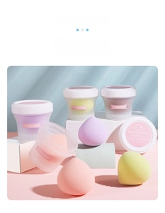 Close-up of heart-shaped makeup sponges in individual cases with aesthetic lighting