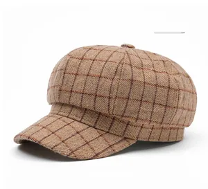Detailed close-up of light tan plaid octagonal hat with vintage wool texture and short brim