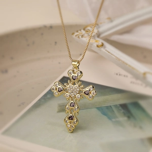 Gold cross necklace with purple heart gemstone and white zircon on a gold box chain