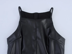 Detail of black faux leather mini dress showing slim straps and back zipper closure