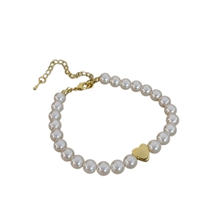 Elegant natural freshwater pearl bracelet with a polished gold heart charm for women