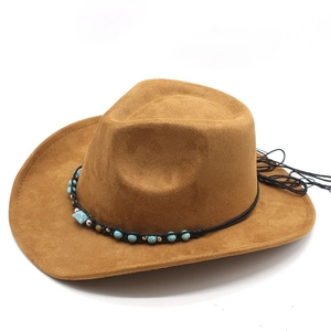 Detail of brown suede cowboy hat with turquoise beads, metal accents, and black tassels