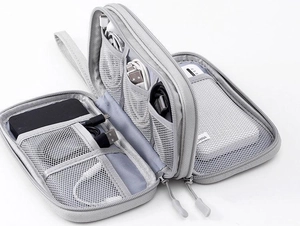 Detailed interior of grey electronics organizer with mesh pockets and elastic straps