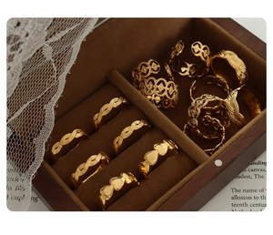 Detail of vintage gold-plated geometric rings set with braided and heart patterns