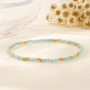 Bohemian style bracelet featuring faceted light blue natural stone and gold metal beads