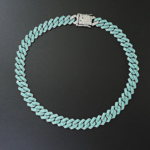 Detail shot of iced out silver Cuban link chain with turquoise rhinestones and square clasp