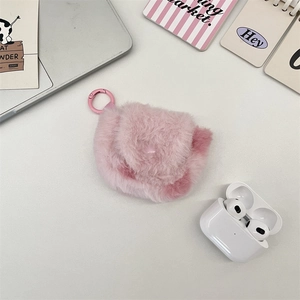 Macro detail of plush pink heart earphone case with a metallic hook and headphones