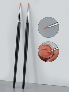 Macro view of ultra-fine eyeliner brush head with metal ferrule and black handle