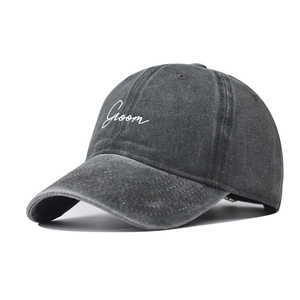 Macro shot of Groom embroidery on vintage washed dark grey cotton baseball cap