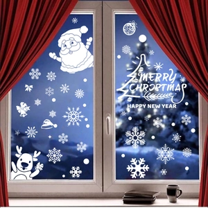 White Christmas window stickers featuring Santa, reindeer, and snowflakes on glass