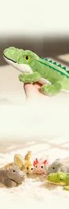 Close-up of soft plush crocodile and group of stuffed animals on a fuzzy carpet