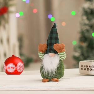 Close-up of a festive Christmas gnome doll with a green plaid hat covering its eyes
