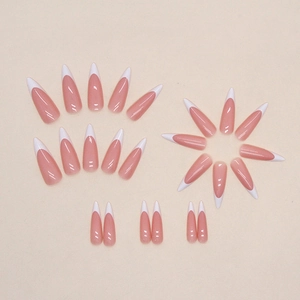 Long stiletto French press-on nails in nude pink and white for a minimalist look