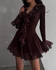 Close-up of deep V-neckline and layered ruffle trim on a chocolate brown mesh mini dress