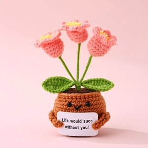 Close-up of crochet pink tulips in a smiling pot with Life would succ without you sign