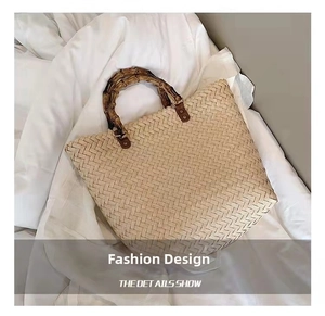 Detailed close-up of retro straw tote bag featuring natural bamboo handle and woven texture