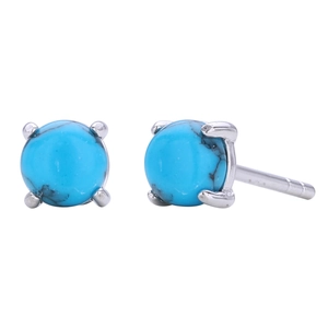 Detailed macro view of round turquoise stud earrings with silver four-prong setting