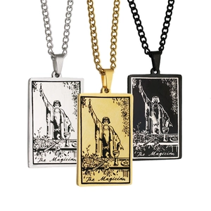 Close-up of The Magician tarot card pendants in silver, gold, and black steel finishes
