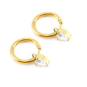 Macro detail of gold hoop earrings with sparkling heart-shaped zircon pendants