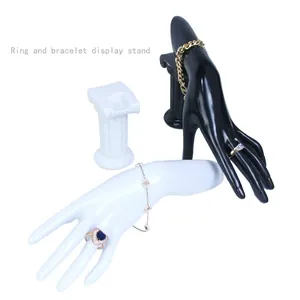 Black and white mannequin hand jewelry display stands with Roman column base