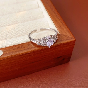 Macro shot of silver ring featuring a purple zircon and leaf-shaped micro-pave crystals
