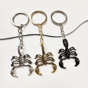 Detailed view of scorpion-shaped alloy keychains in silver, gold, and black finishes