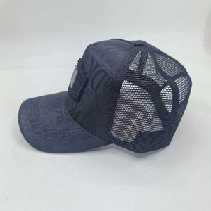 Detail view of dark grey mesh trucker hat with signature oblique pattern and logo plaque
