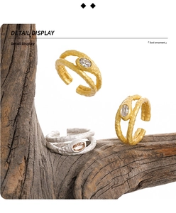 Close-up of S925 sterling silver hammered rings with zircon stone on wood texture