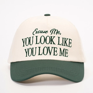 Two-tone beige and dark green baseball cap with Excuse Me You Look Like You Love Me embroidery