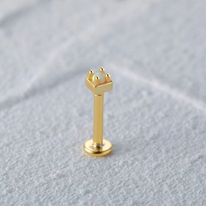 Macro shot of S925 sterling silver gold-plated opal labret stud with engraved hallmark