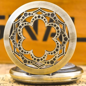 Macro shot of vintage bronze pocket watch with intricate floral hollow carved cover