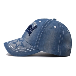 Washed blue denim baseball cap with navy embroidery and star print on the brim