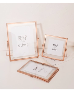 Detail of rose gold iron picture frame with 6x8in size display and glass front