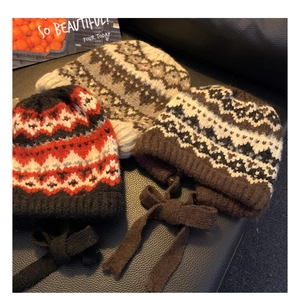 Detail of retro knit earflap beanies with geometric patterns in various color combinations