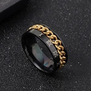 Macro shot of rotatable gold chain link on black stainless steel ring with Roman numerals