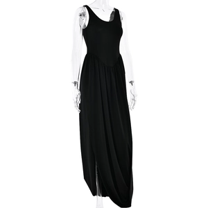 Detail of elegant black backless maxi dress with high slit and draped fabric texture