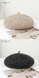 Detail view of leopard print wool berets in beige and dark grey with soft texture