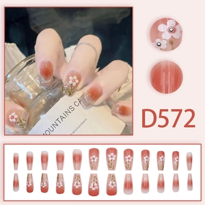 Orange cat eye press-on nails with 3D white flowers and gradient coffin design