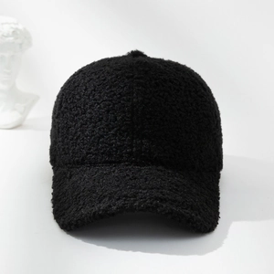 Detailed texture of black plush fleece fabric on a warm winter baseball cap