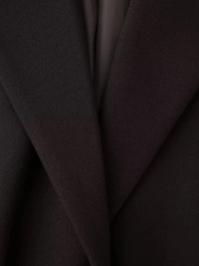 Detailed close-up of dark woolen coat collar and smooth satin lining texture