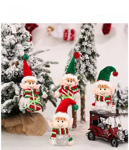 Christmas elf doll ornament and candy jar among holiday decorations on snow