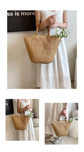 Detailed view of natural straw tote with vintage bamboo handles and gold metal rings