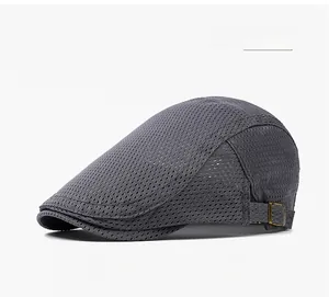 Close-up of dark grey mesh newsboy cap with bronze adjustable metal side buckle