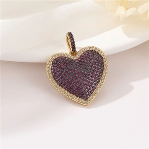 Detail of 14k gold plated heart pendant with pink and clear cubic zirconia stones