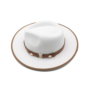 Detail view of white wool fedora with brown bound edge and metallic buckle leather band