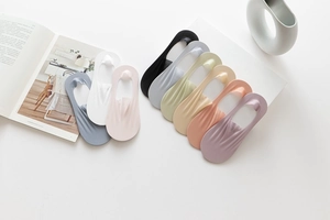 Detailed flat lay of ten colorful thin cotton invisible boat socks for women on white desk
