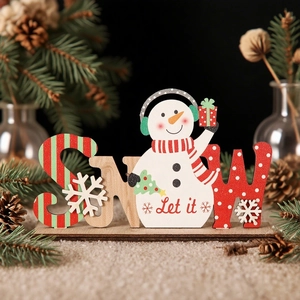 Detail of wooden SNOW letter sign with snowman figurine and festive pine cones background