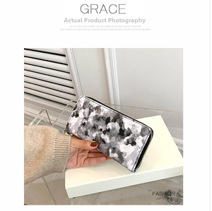 Detail view of the long marble pattern women's wallet with golden zipper closure