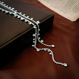 Detailed close-up of sparkling rhinestone tassels on a silver luxury fringe necklace